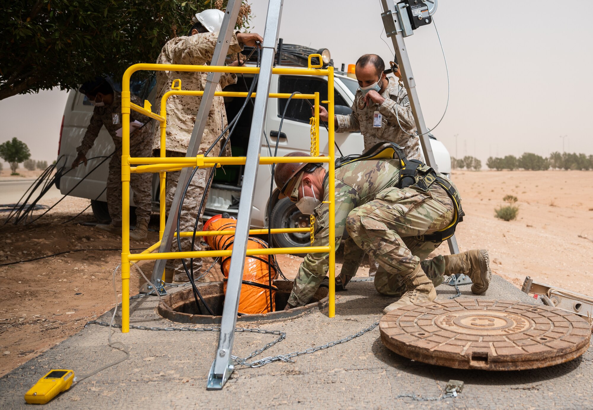 Service members from the U.S. and Royal Saudi Air Forces perform a fiber optic repair at Prince Sultan Air Base, Kingdom of Saudi Arabia, March 17, 2022. Training alongside RSAF partners contributes to developing the capabilities and skills of base personnel in operational and combat environments. (U.S. Air Force photo by Senior Airman Jacob B. Wrightsman)