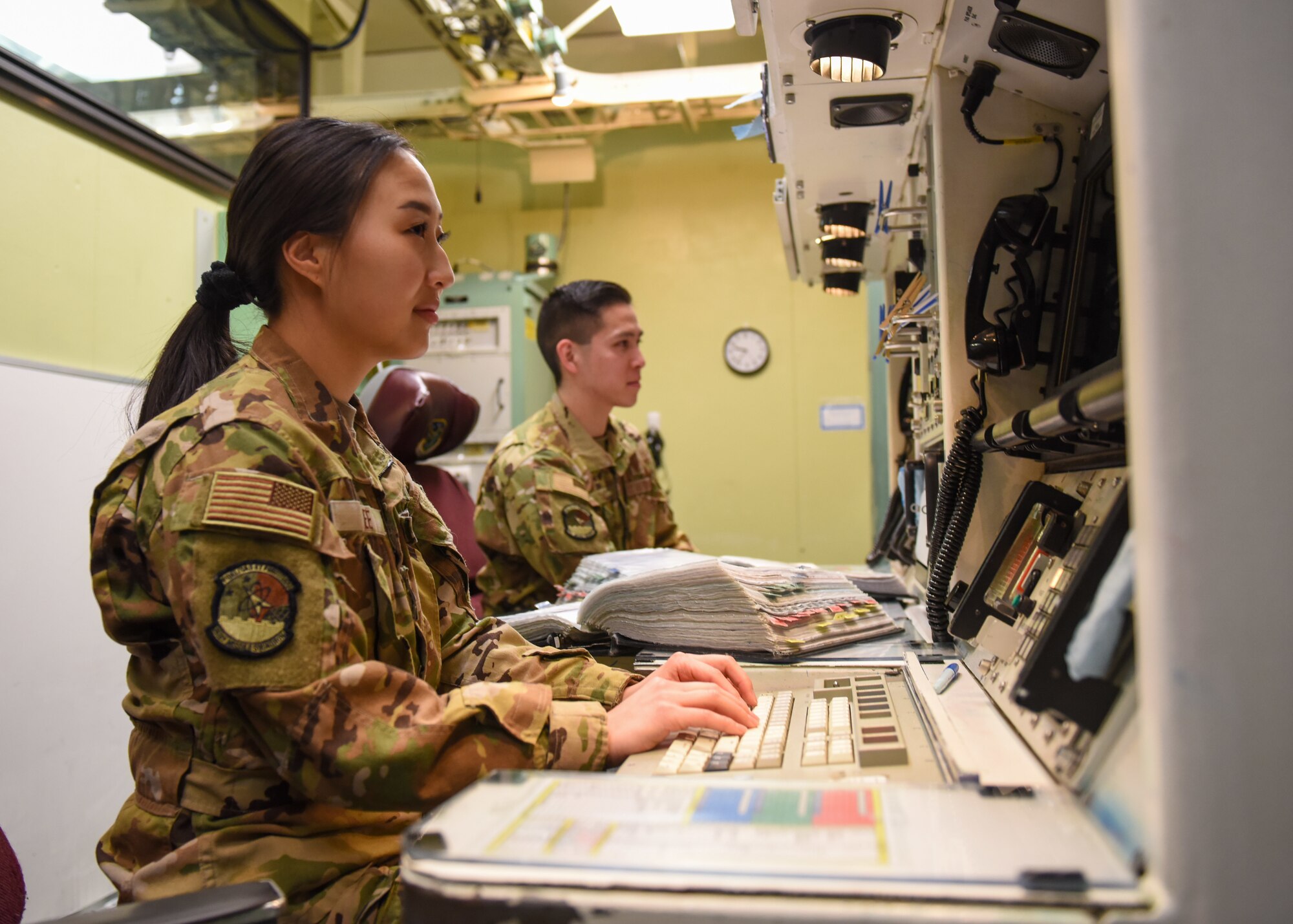 Missileers sit at a control console