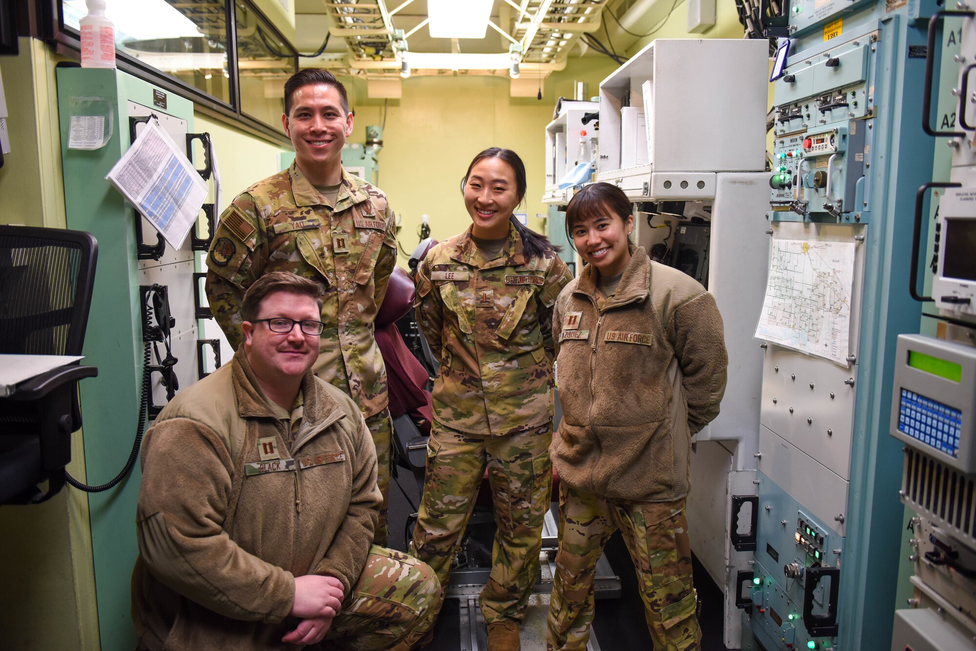 Missileers sit at a control console