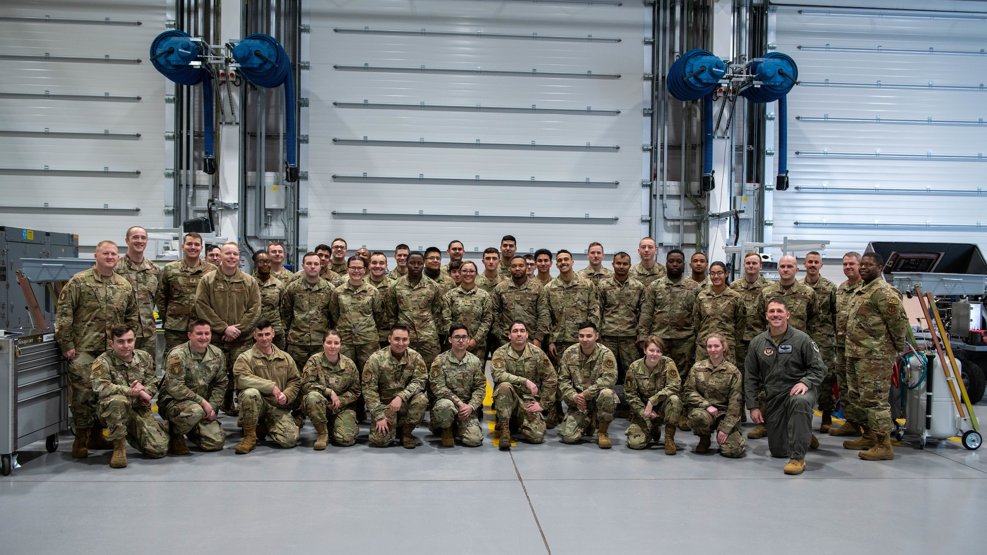 Airmen gather for a group photo after a ribbon cutting ceremony.
