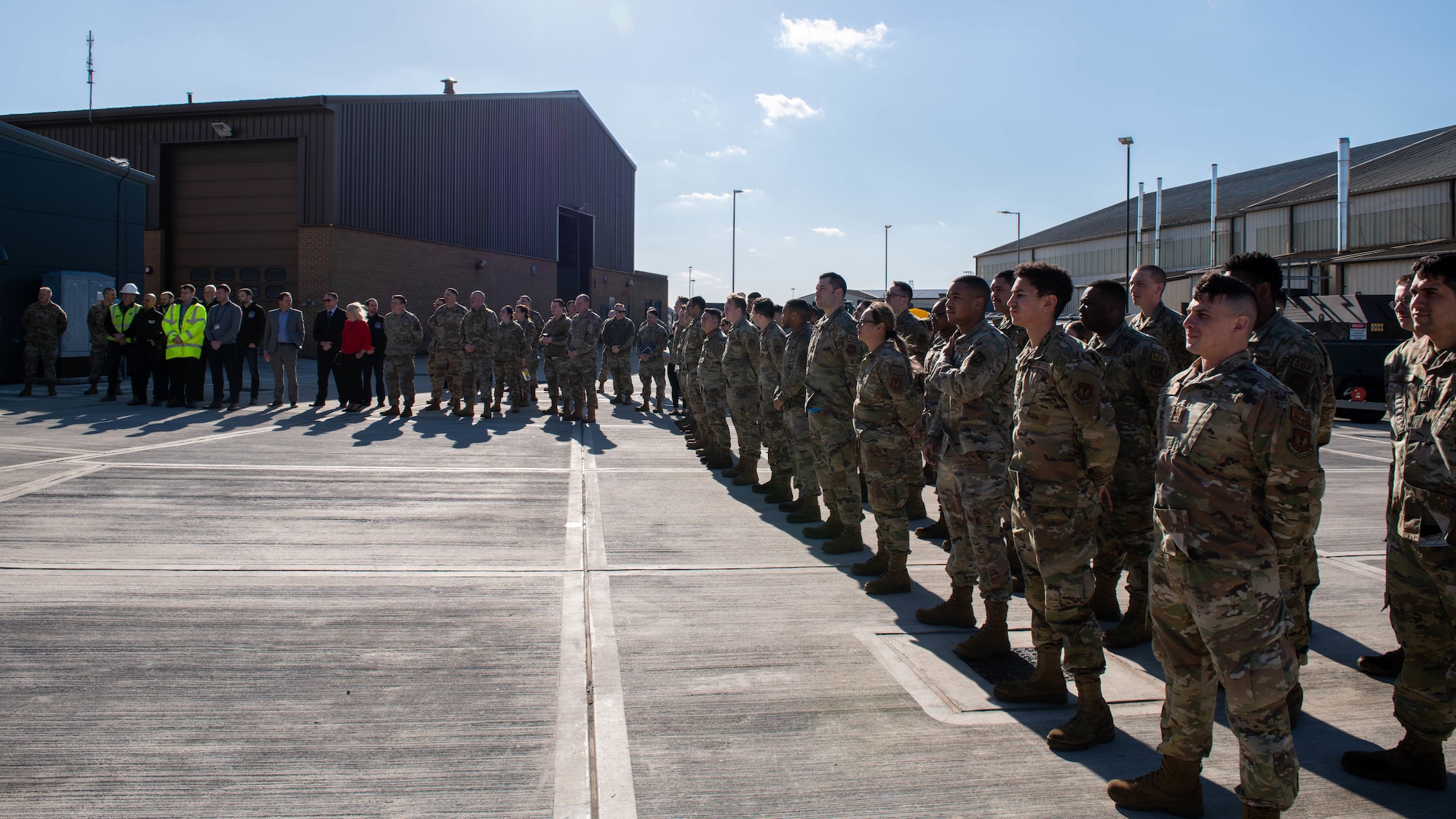 Airmen and staff watch the ribbon cutting ceremony