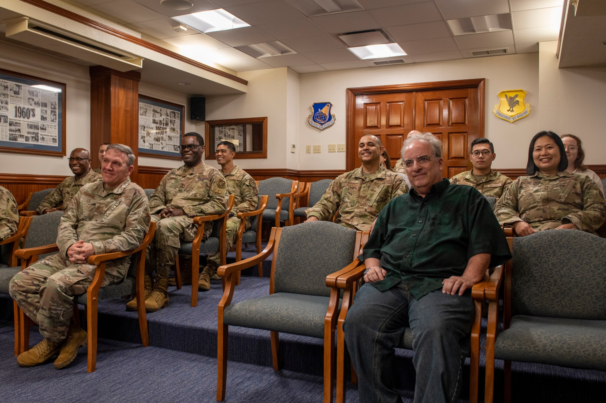 Airmen and civilians from the 18th Wing Staff Agency listen to U.S. Air Force Brig. Gen. David Eaglin