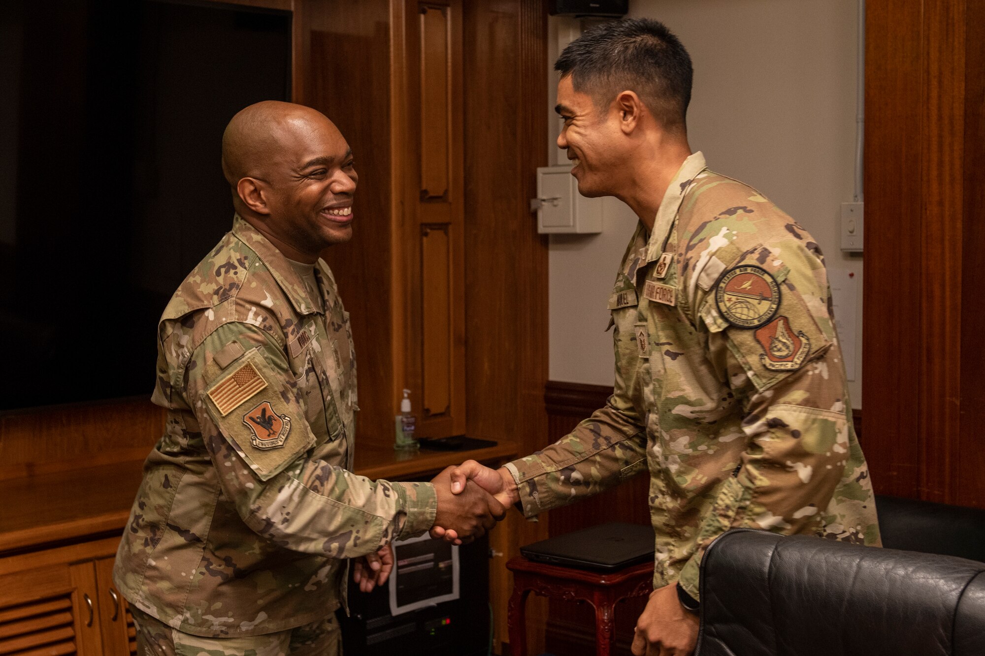 Chief Master Sgt. Ronnie Woods shakes hands with an annual award nominee