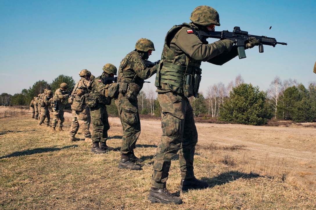 Paratroopers and Polish soldiers engage targets during a combined live-fire training event.