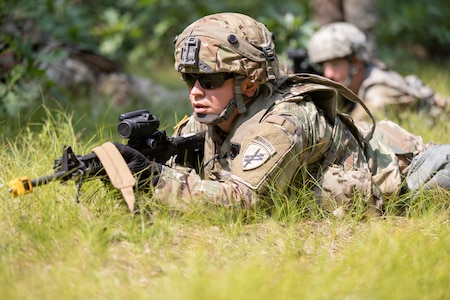 Staff Sgt. Jamie Karohn, a psychological operations specialist with the 13th Psychological Operations Battalion, 2nd Psychological Group, United States Army Civil Affairs and Psychological Operations Command, covers her sector of fire as a squad leader during react to fire training as part of Exercise Pershing Strike 21 at Fort McCoy, Wis., July 19, 2021. The 13th POB is preparing for an upcoming deployment to AFRICOM. (U.S. Army National Guard photo by Spc. Iain Jaramillo)