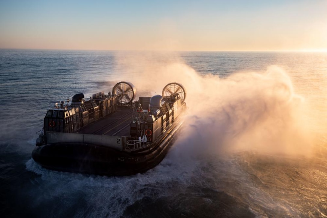 A U.S. Navy landing craft, air cushion with Assault Craft Unit 4, departs amphibious assault ship USS Kearsarge to transport Marines with the 22nd Marine Expeditionary Unit, March 18, 2022. The 22nd MEU, in conjunction with the Kearsarge Amphibious Ready Group, serves as a sea-based, expeditionary crisis response force capable of conducting amphibious missions across the full range of military operations.