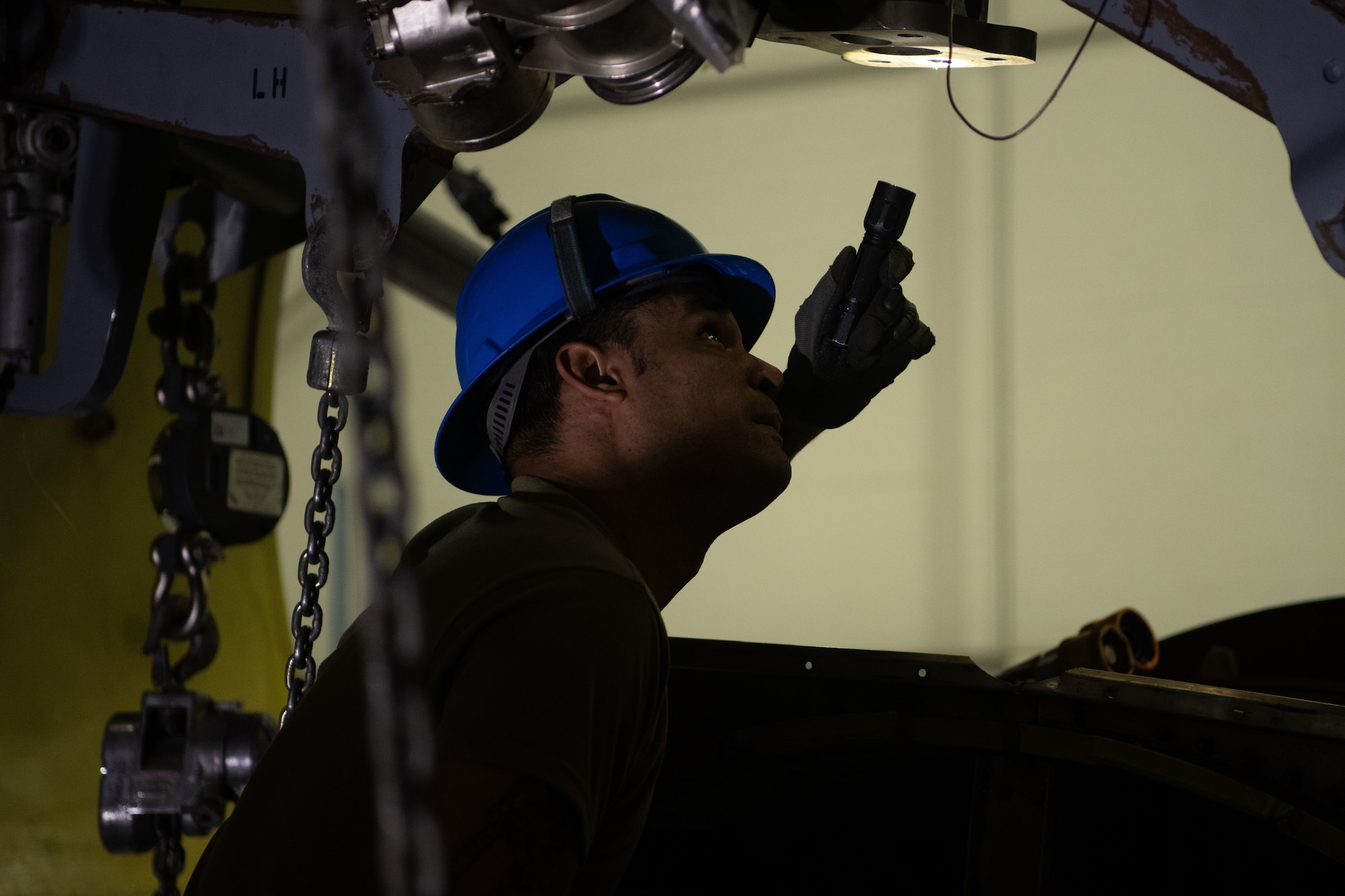 The engine raising process requires precise coordination between a team of at least four Airmen to ensure proper engine installment.