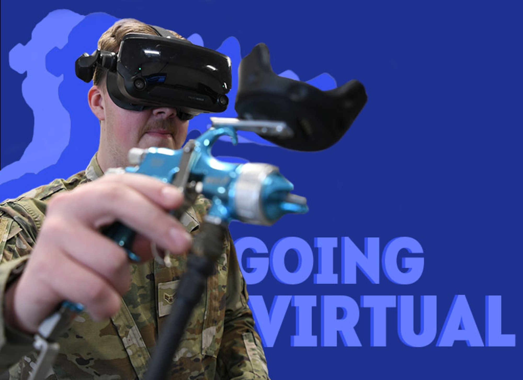 An Airman stands with a painting gun on a blue background with the text 'going virtual' to viewer's right.