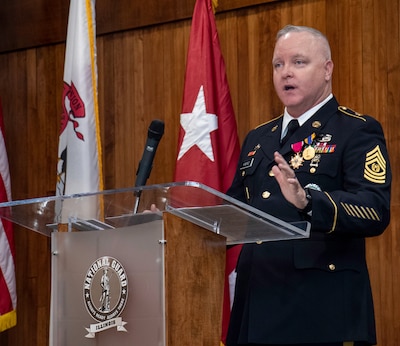 Command Sgt. Maj. Paul Kindred, of Jacksonville, Illinois, Human Resources Office Sergeant Major, Illinois National Guard, thanks family and friends for their support during his more than two-decade military career, during a retirement ceremony March 18 at the Illinois Military Academy, Camp Lincoln, Springfield, Illinois.