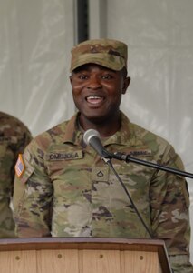 Pfc. Samuel Omojola sings the German national anthem during the ribbon cutting ceremony for the U.S. Army Medical Materiel Center-Europe in Kaiserslautern Sept. 17, 2021. Now promoted to specialist, Omojola has been accepted into the U.S. Army Europe Band & Chorus.