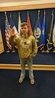 A man raises his right hand, taking the oath of enlistment to join the Army.