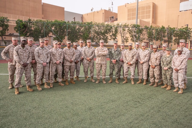 U.S. Marines and Sailors with the Directorate of Logistics, Task Force 51/5th Marine Expeditionary Brigade (TF 51/5) pose for a group photo, Mar. 9. TF 51/5 Directorate of Logistics was recognized as the Logistics Unit of the Year (Small Unit) for the Fiscal Year 21 Marine Corps Award for Installations And Logistics Excellence. (U.S. Marine Corps photo by Staff Sgt. Victor A. Mancilla)