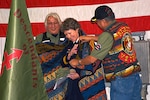 Wisconsin National Guard Brig. Gen. Joane Mathews receives a ceremonial blanket as a sign of respect and honor after speaking at the 40th Annual Descendants of Red Arrow Veterans Day Pow-Wow Nov. 11, 2017. The Volk Field ceremony honored 28 Native Americans who served in the Wisconsin National Guard’s Company D, 128th Infantry, 32nd Division, during World War I.