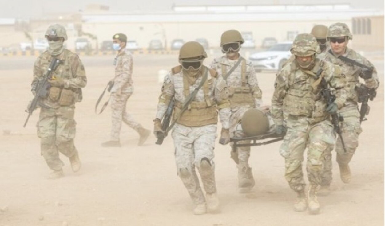 U.S. and Saudi Soldiers carry another Soldier during training.