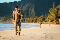 Soldiers with the Sensor Management Cell assigned to the 94th Army Air and Missile Defense Command, perform a tactical beach road march on Bellows Air Force Station, Waimanalo, Hawaii, on March 27, 2018. The weeklong competition tested the Soldiers during individual and team competitive events. (U.S. Army photo by Capt. Adan Cazarez)