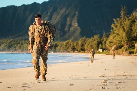 Soldiers with the Sensor Management Cell assigned to the 94th Army Air and Missile Defense Command, perform a tactical beach road march on Bellows Air Force Station, Waimanalo, Hawaii, on March 27, 2018. The weeklong competition tested the Soldiers during individual and team competitive events. (U.S. Army photo by Capt. Adan Cazarez)