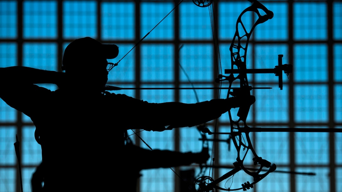 A wounded warrior practices archery.