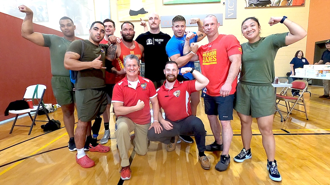 Wounded warriors pose for a photo after a weight lifting competition.