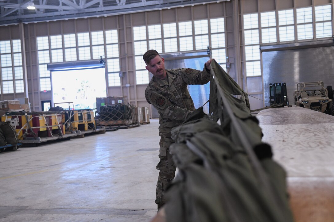 Technical Sgt. Jacob McKague, 920th Logistics Readiness Squadron rigger and aerial porter, completes gore fold inspections on a parachute at Patrick Space Force Base, Fla., March 17, 2022.