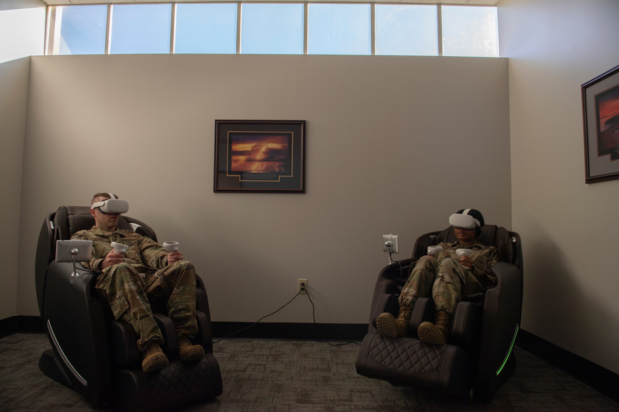 A photo of two Airmen sitting in massage chairs.