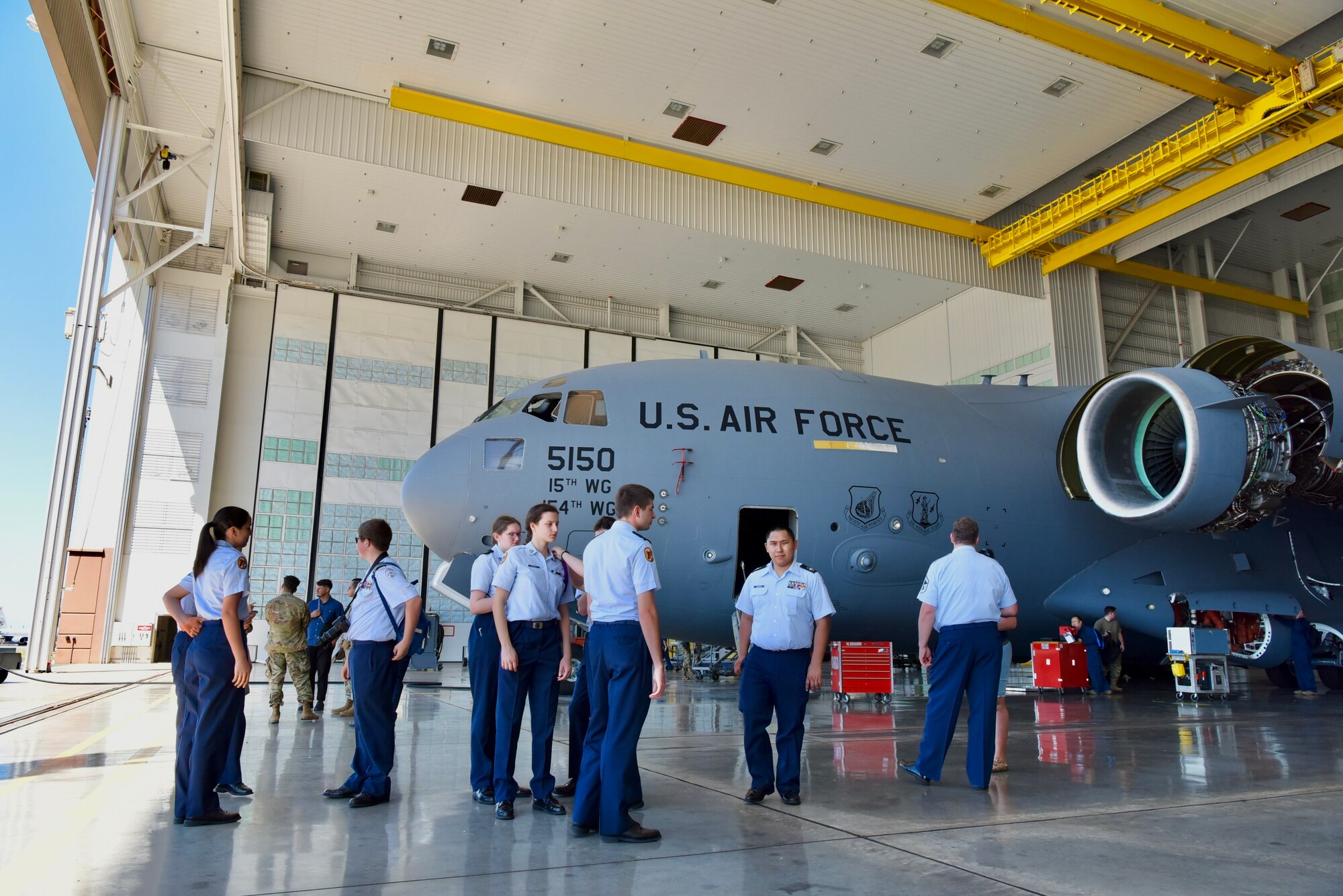 Cadets from West Anchorage High School Junior ROTC learn about a C-17 Globemaster III during a tour at Joint Base Pearl Harbor-Hickam, Hawaii, March 21, 2022. Cadets traveled all the way from Alaska as part of a unit trip to visit Hawai’i and see an active duty military base to include a tour of the USS Hopper and a C-17 static. (Air Force photo by 1st Lt. Benjamin Aronson)