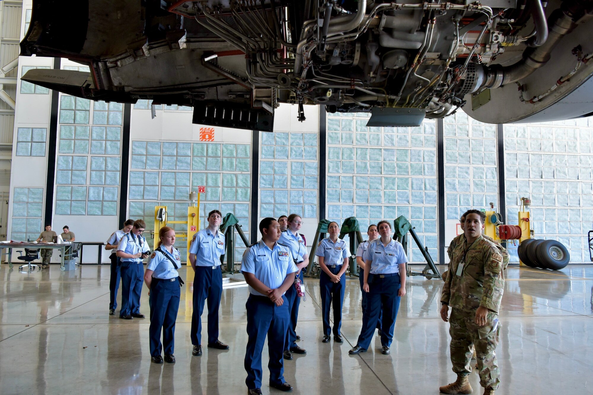 Cadets from West Anchorage High School Junior ROTC tour a C-17 Globemaster III undergoing a routine inspection as part of a tour at Joint Base Pearl Harbor-Hickam, Hawaii, March 21, 2022. Cadets learned about the C-17’s capabilities and talked with 15th Wing maintainers about their career fields. (Air Force photo by 1st Lt. Benjamin Aronson)