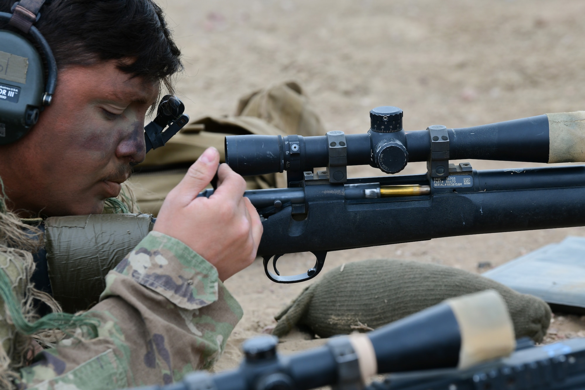 an airmen ejects a cartridge from his weapon