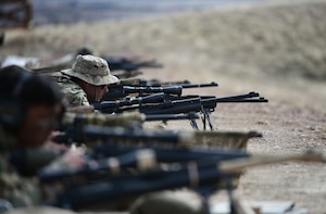 Airmen aim their weapons