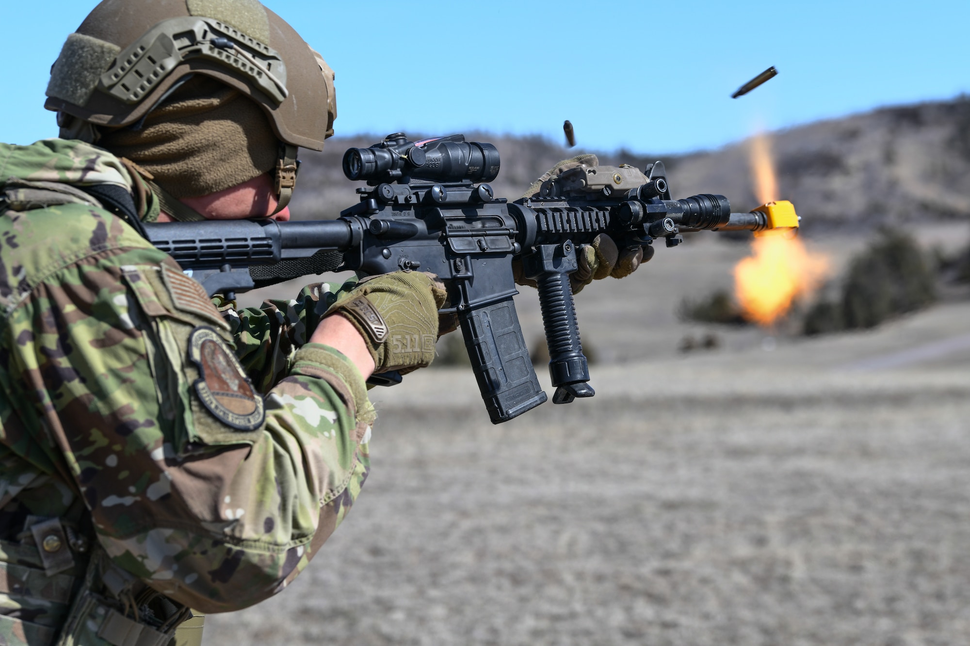 An Airmen fires a weapon.