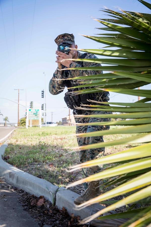 U.S. Marine Corps 1st Lt. Dane J. Angell, a military police officer with the Marine Corps Air Station Miramar’s Provost Marshal Office, detects the speed of passing cars on Miramar Way on MCAS Miramar, San Diego, California, March 10, 2022. MCAS Miramar recently enacted new speed limits on some base roads in order to promote the safety of all patrons on the base. (U.S. Marine Corps photo by Lance Cpl. Jose GuerreroDeLeon)