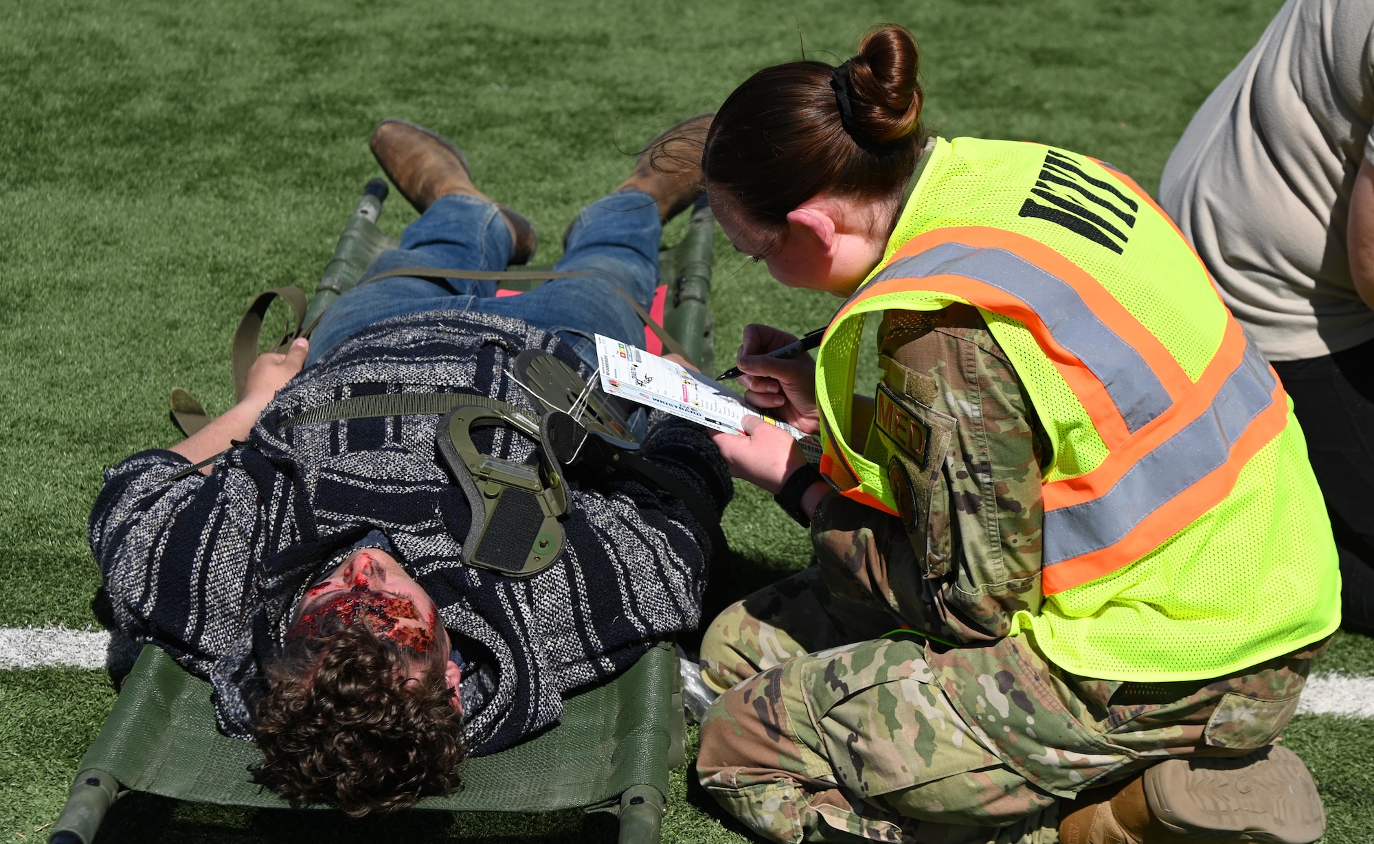 An Airman fills out a triage tag during a mass casualty exercise.