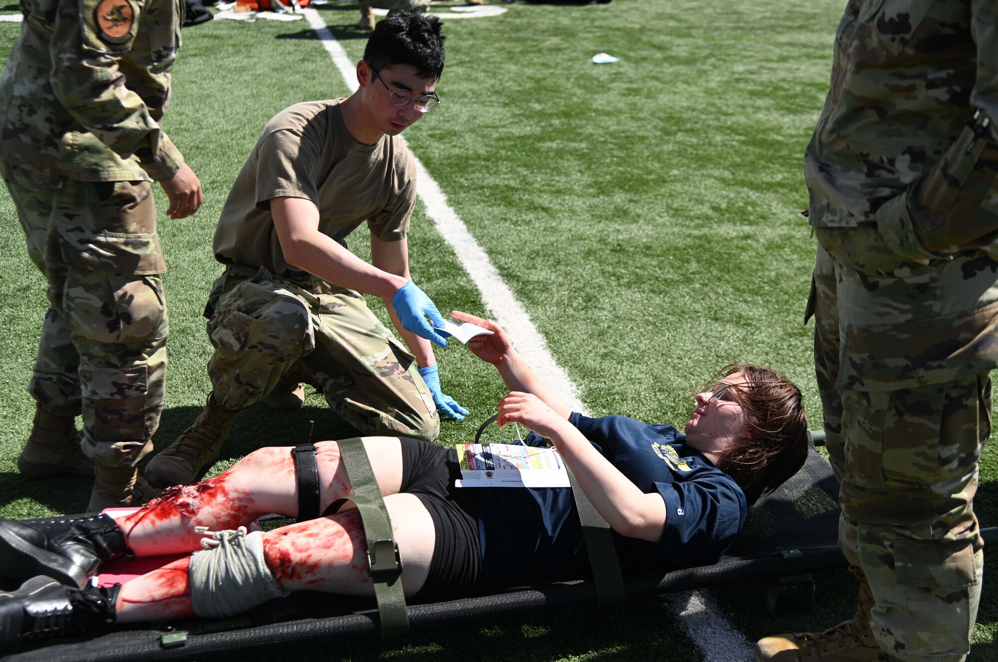 An Airman triages a simulated patient.