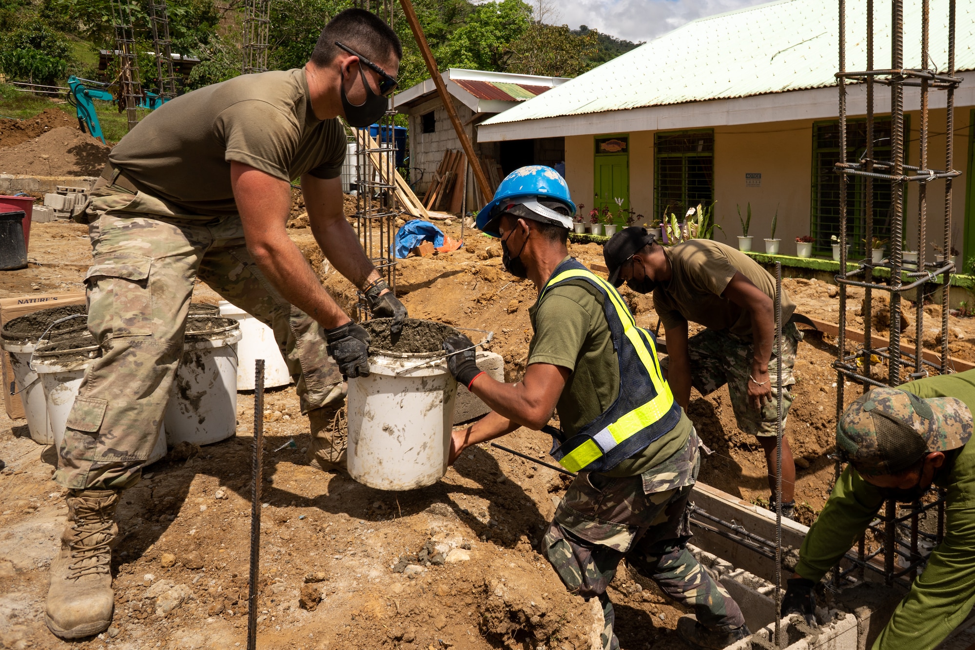 Members of the Armed Forces of the Philippines and U.S. Air Force 18th Civil Engineer Group, 18th Wing, work on constructing a schoolhouse.