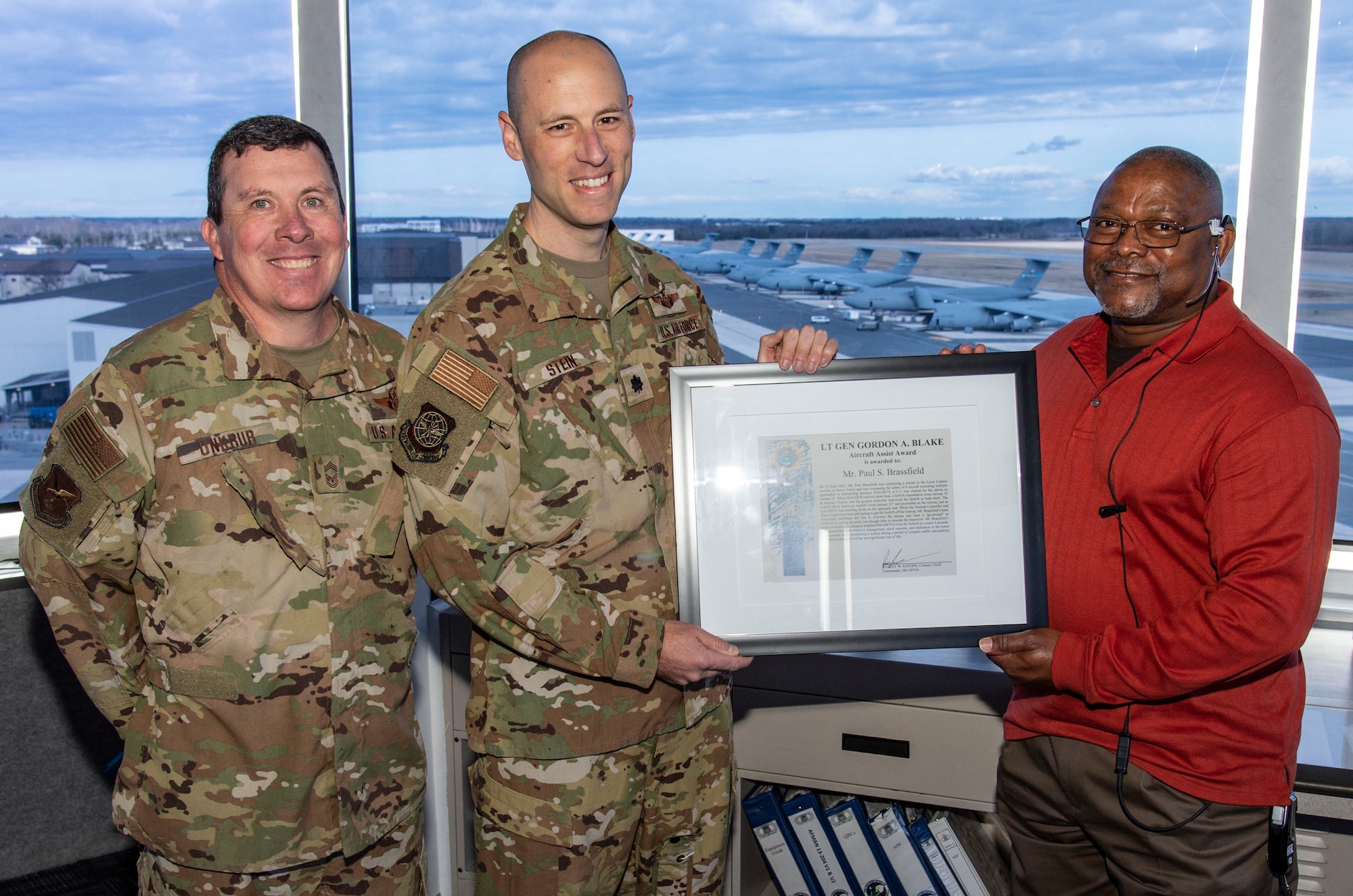 Chief Master Sgt. Daniel Unkrur, left, 436th Operations Group superintendent; and Lt. Col. Andrew Stein, center, 436th OG deputy commander, present Paul Brassfield, 436th Operations Support Squadron air traffic control tower watch supervisor, with the Lt. Gen. Gordon A. Blake Aircraft Assist Award at Dover Air Force Base, Delaware, March 3, 2022. Brassfield�s quick reaction, exceptional crew resource management and dedication to the tower team concept prevented a potential aircraft mishap and significant loss of life. (U.S. Air Force photo by Roland Balik)