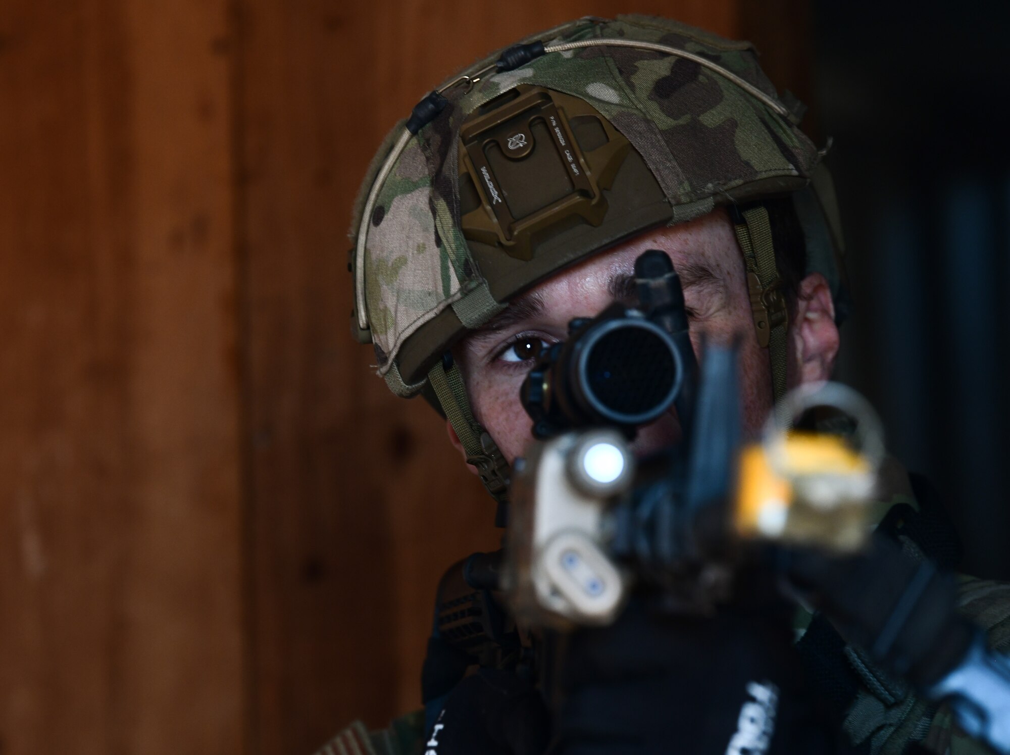 An Airmen aims a weapon