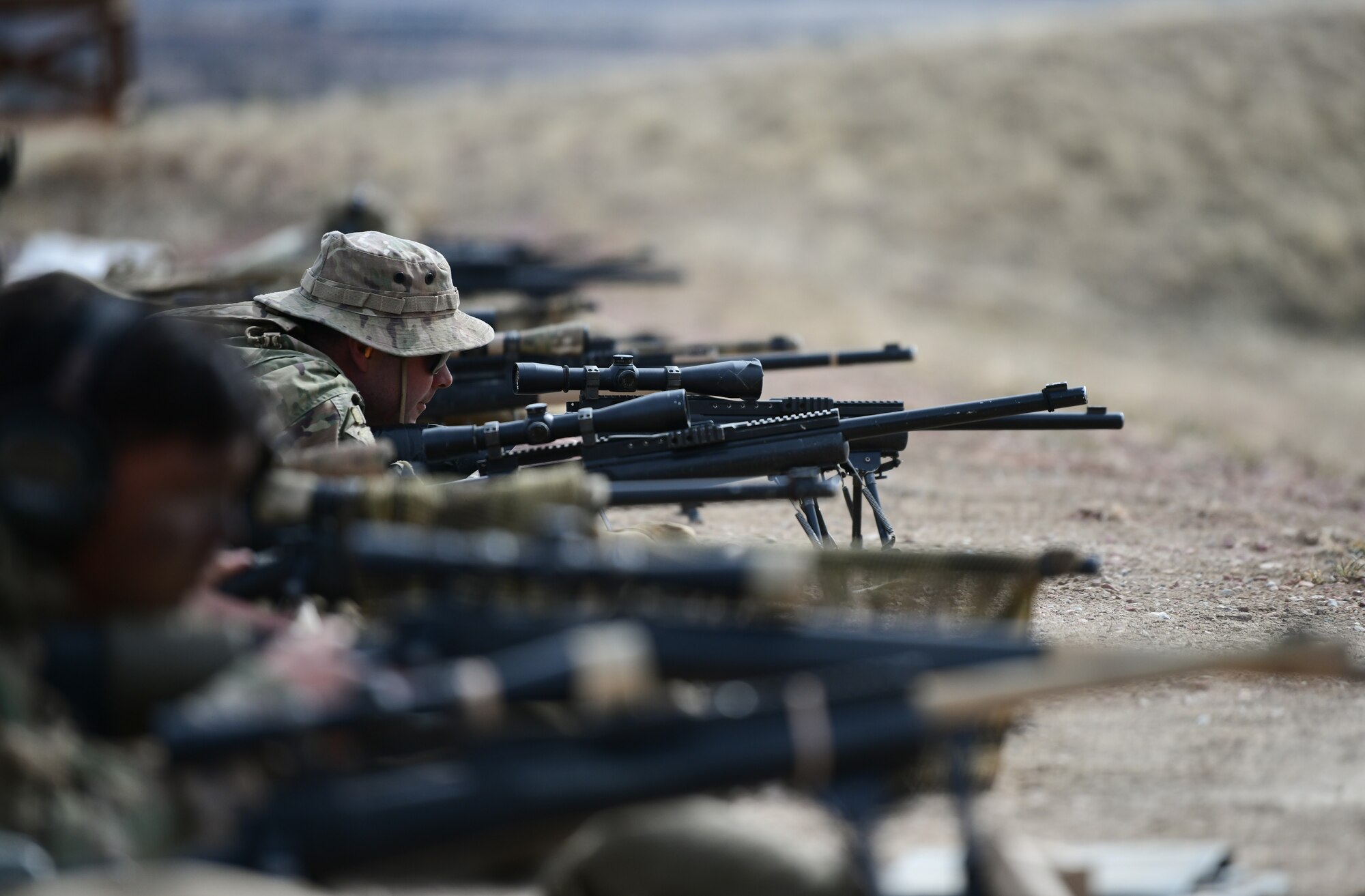 Airmen aim their weapons