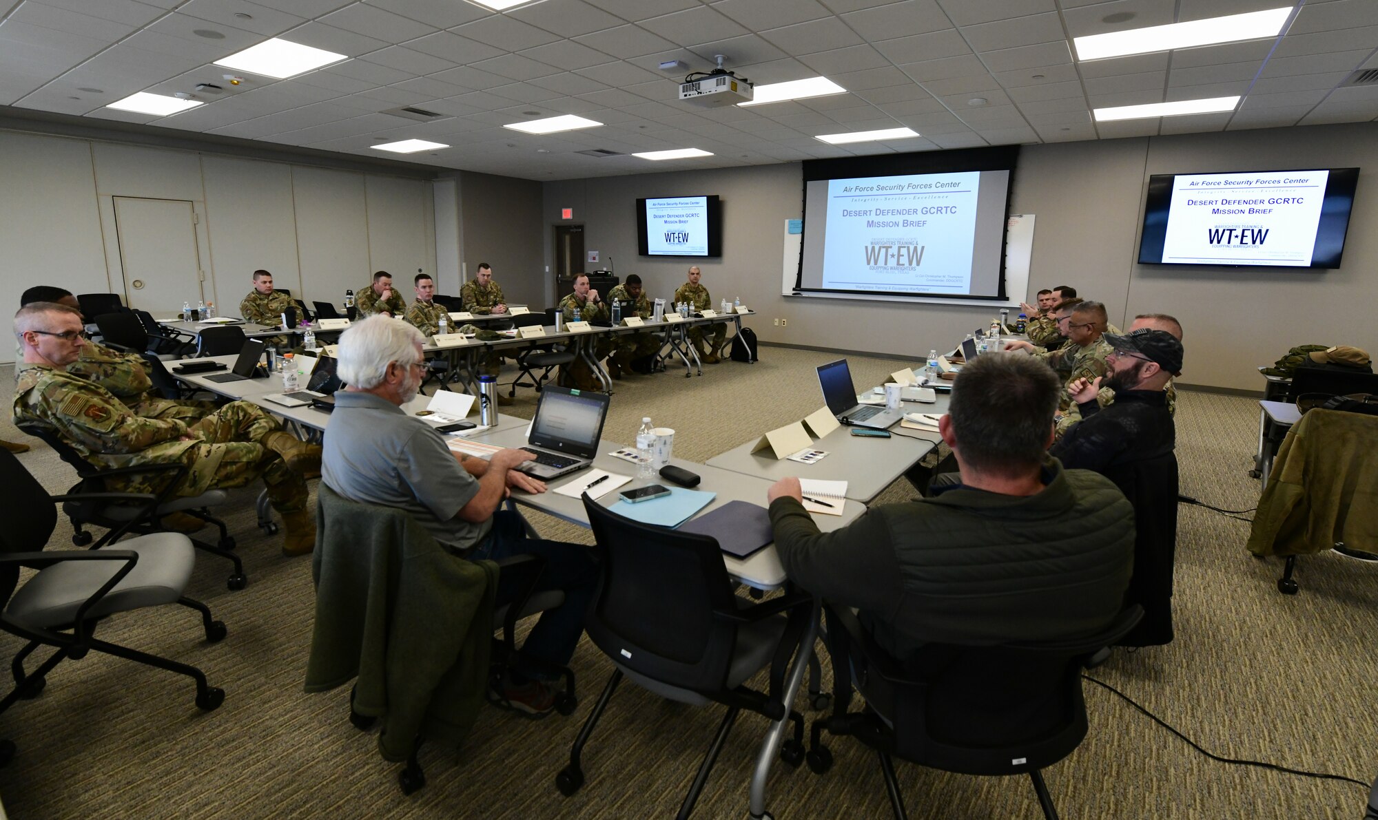Defender leaders sit in a conference