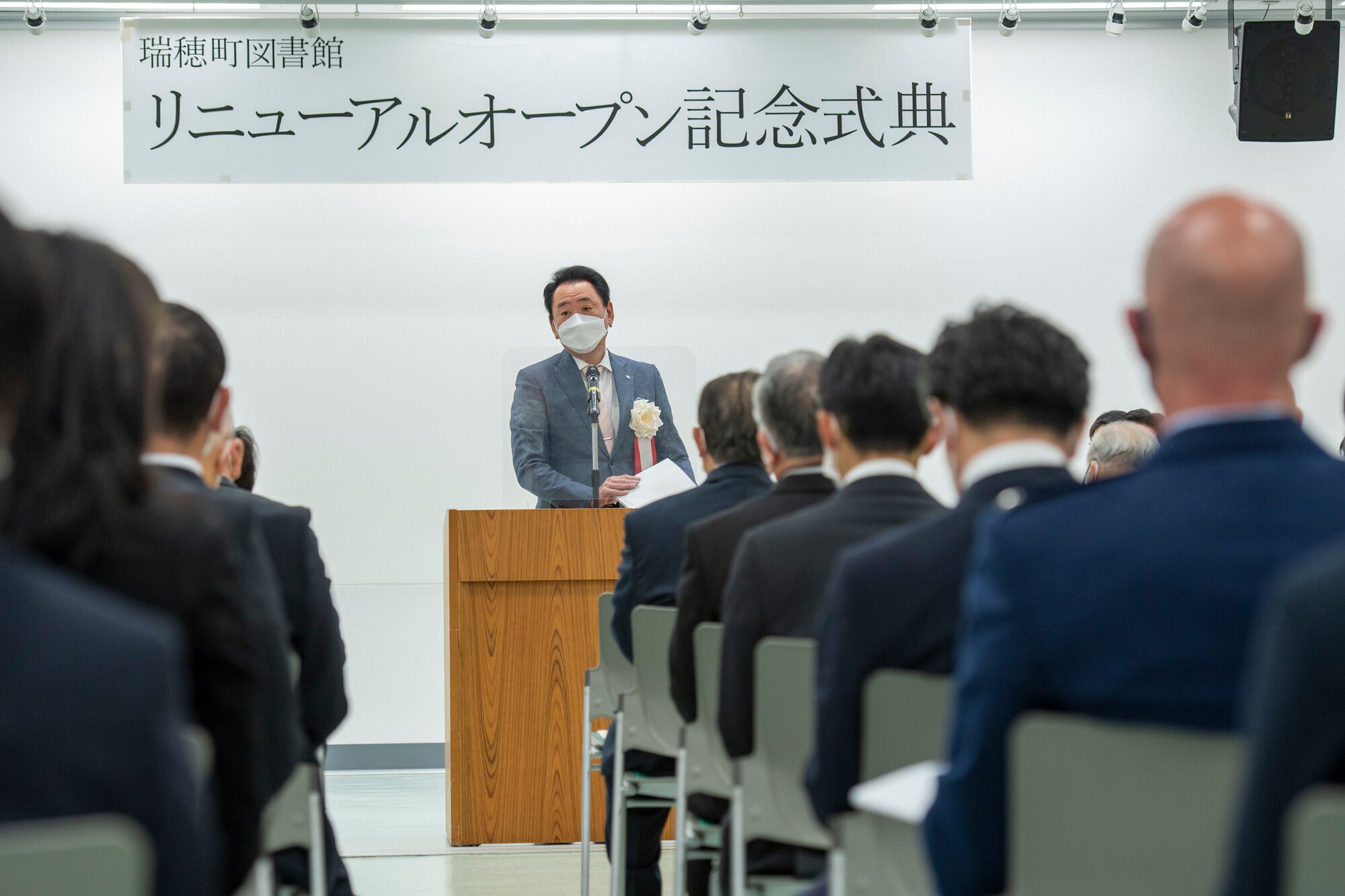 The mayor of Mizuho town speaks to room full of listeners