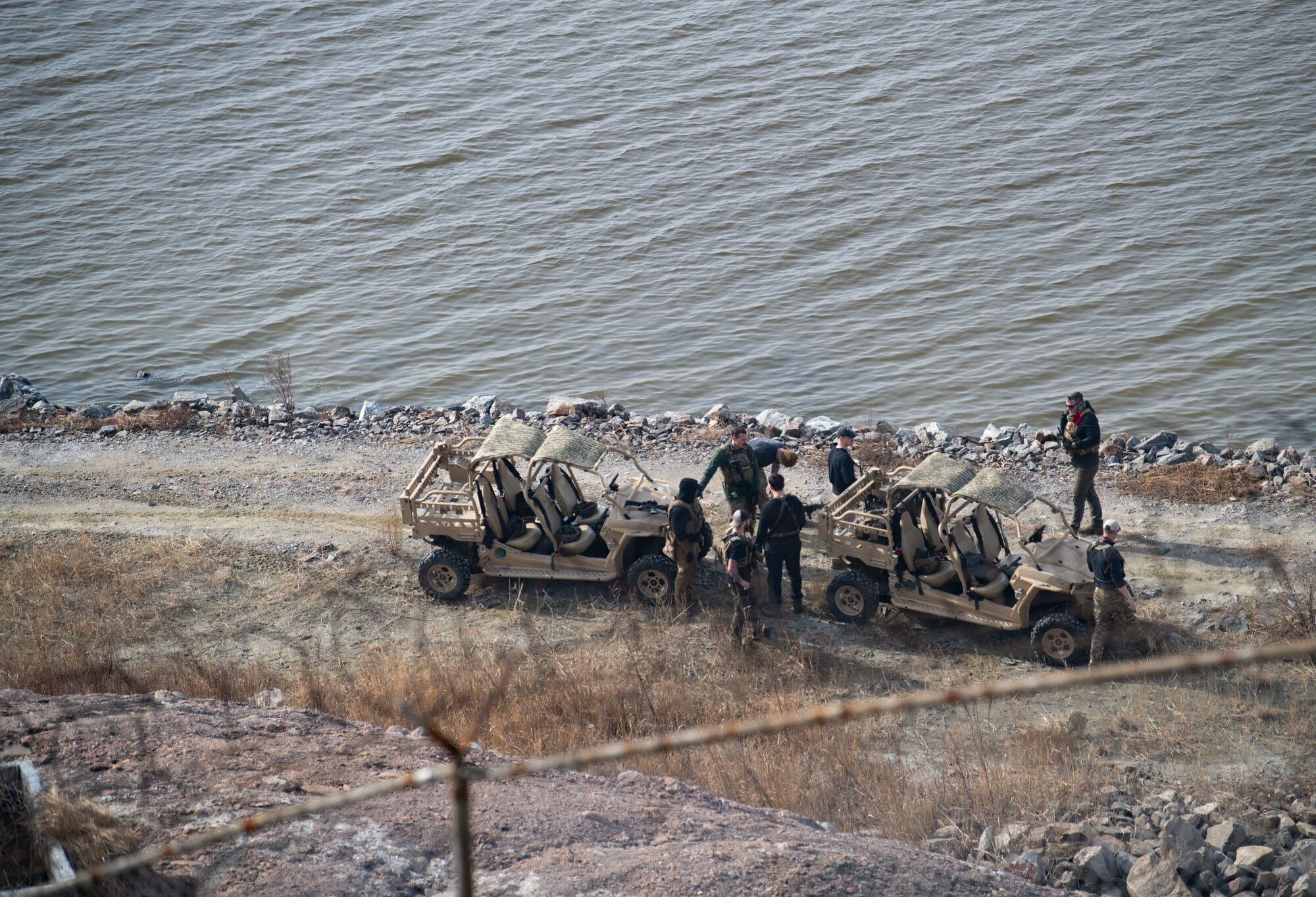 Airmen acting as an opposing force strike team prepare to ambush 8th Security Forces Squadron Defenders in order to test their ability to rapidly respond and counter base threats at Kunsan Air Base, Republic of Korea, March 10, 2022.
