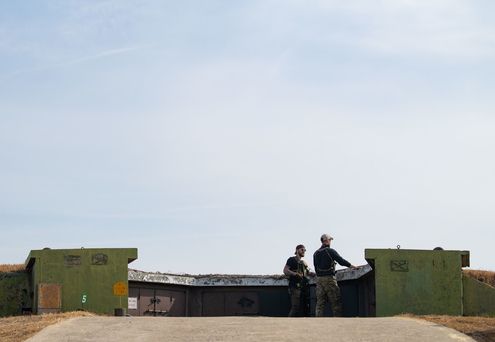Airmen acting as an opposing force strike team prepare to ambush 8th Security Forces Squadron Defenders in order to test their ability to rapidly respond and counter base threats at Kunsan Air Base, Republic of Korea, March 10, 2022.
