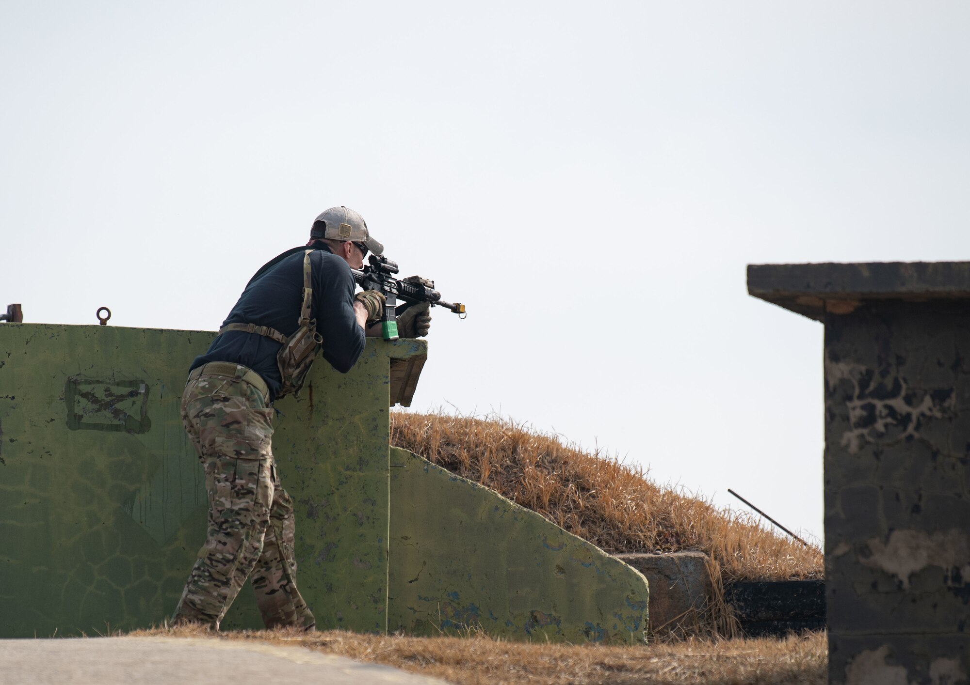 Airmen acting as an opposing force strike team prepare to ambush 8th Security Forces Squadron Defenders in order to test their ability to rapidly respond and counter base threats at Kunsan Air Base, Republic of Korea, March 10, 2022.