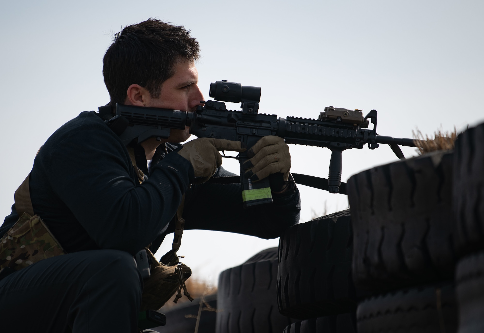 Airmen acting as an opposing force strike team prepare to ambush 8th Security Forces Squadron Defenders in order to test their ability to rapidly respond and counter base threats at Kunsan Air Base, Republic of Korea, March 10, 2022.