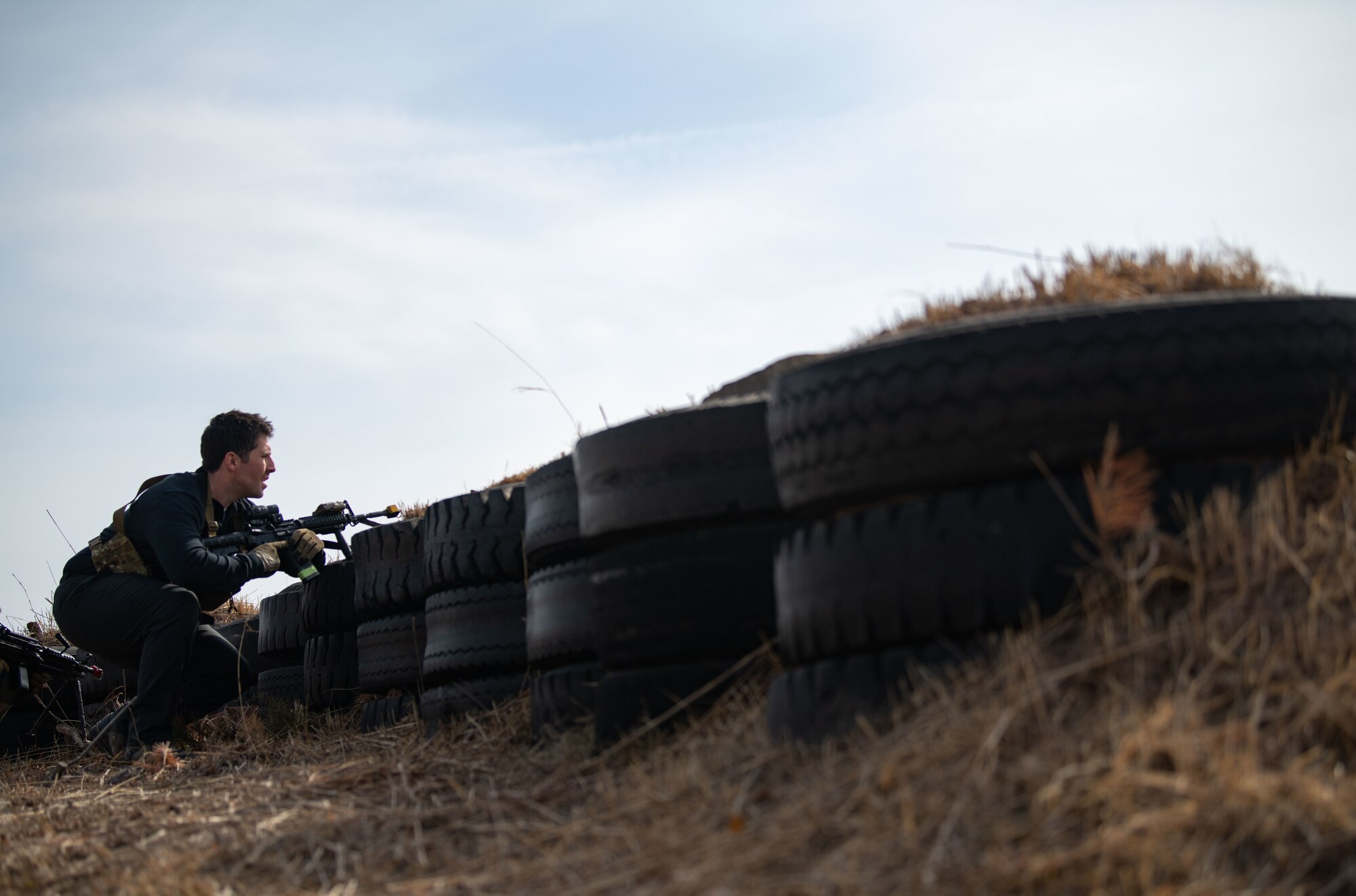 Airmen acting as an opposing force strike team prepare to ambush 8th Security Forces Squadron Defenders in order to test their ability to rapidly respond and counter base threats at Kunsan Air Base, Republic of Korea, March 10, 2022.