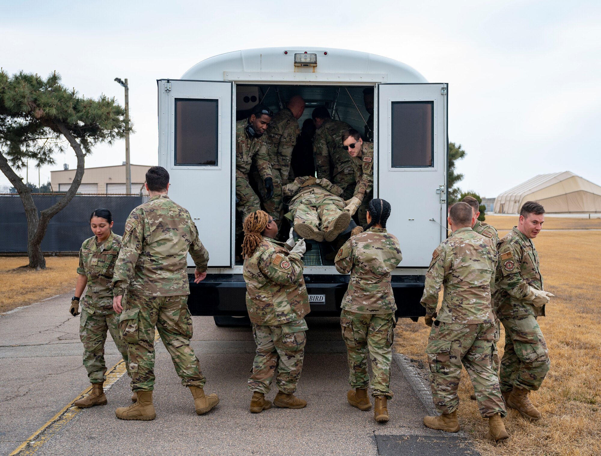 Airmen assigned to the 8th Medical Group carry a mock-casualty to a C-12 Huron during training at Kunsan Air Base, Republic of Korea, March 11, 2022.