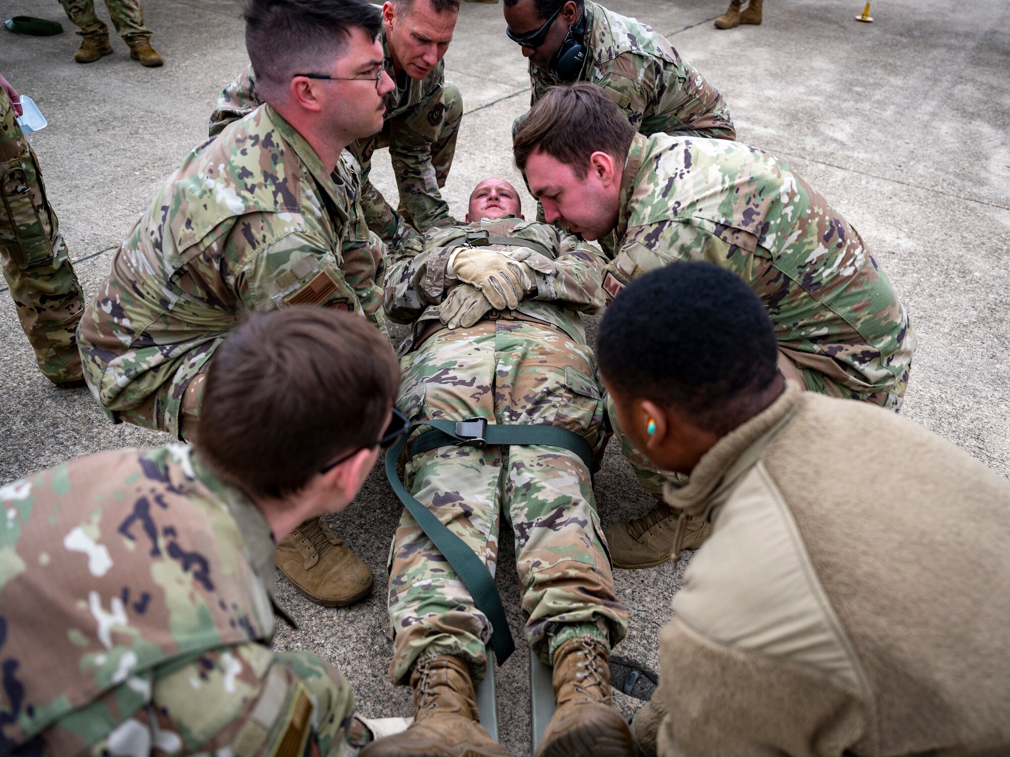 Airmen assigned to the 8th Medical Group carry a mock-casualty to a C-12 Huron during training at Kunsan Air Base, Republic of Korea, March 11, 2022.