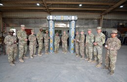 Command Sgt. Maj. Michael J. Perry III, senior enlisted advisor, 1st Theater Sustainment Command, and Command Sgt. Maj. Phelicea M. Redd, senior enlisted advisor, 1st TSC operational command post, pose with Soldiers assigned to the 389th Combat Sustainment Support Battalion at Camp Buehring, Kuwait, Mar. 2, 2022. The Soldiers, from the allied trades section of the 1063rd Support Maintenance Company, built a noncommissioned officer arch in preparation of an NCO induction ceremony scheduled later in the year.