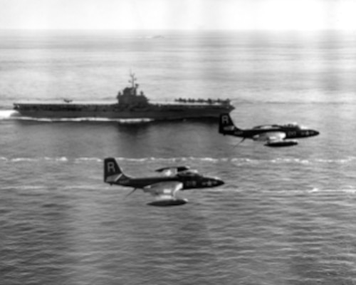 NH 97270 USS Essex (CV-9) Underway during her first Korean War deployment, circa August 1951-March 1952. Two F2H-2 Banshees of Fighter Squadron 172 (VF-172) are flying by in the foreground, preparing to land. Nearest plane is Bureau # 124954. The other is probably Bu # 124969.