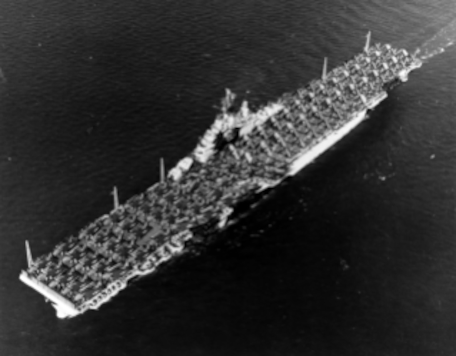 USS ESSEX (CV-9) At sea, with an overload of aircraft on her flight deck, 14 May 1944. She is carrying at least 36 TBF, 14 F6F and 70 SB2C type planes, probably to build up fleet stocks for the Marianas Operation.