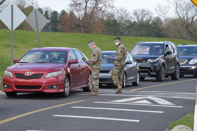 Staff Sgt. Maxwell Dalrymple and 1st Lt. Alex Kriebel check the registered roster as members of the community arrive at a COVID-19 testing site at Montgomery County Community College in Blue Bell, Pa., on April 16, 2020. Members of the Pennsylvania National Guard's Task Force Associator, 1/111th Infantry Regiment, from Plymouth Meeting, Pa., are aiding and monitoring COVID-19 self testing at the site.