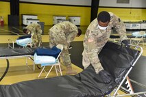 Pennsylvania National Guard members inspect and pack special needs cots at the Glen Mills School in Delaware County, Pennsylvania, on April 14, 2020, for shipment to East Stroudsburg, Monroe County.